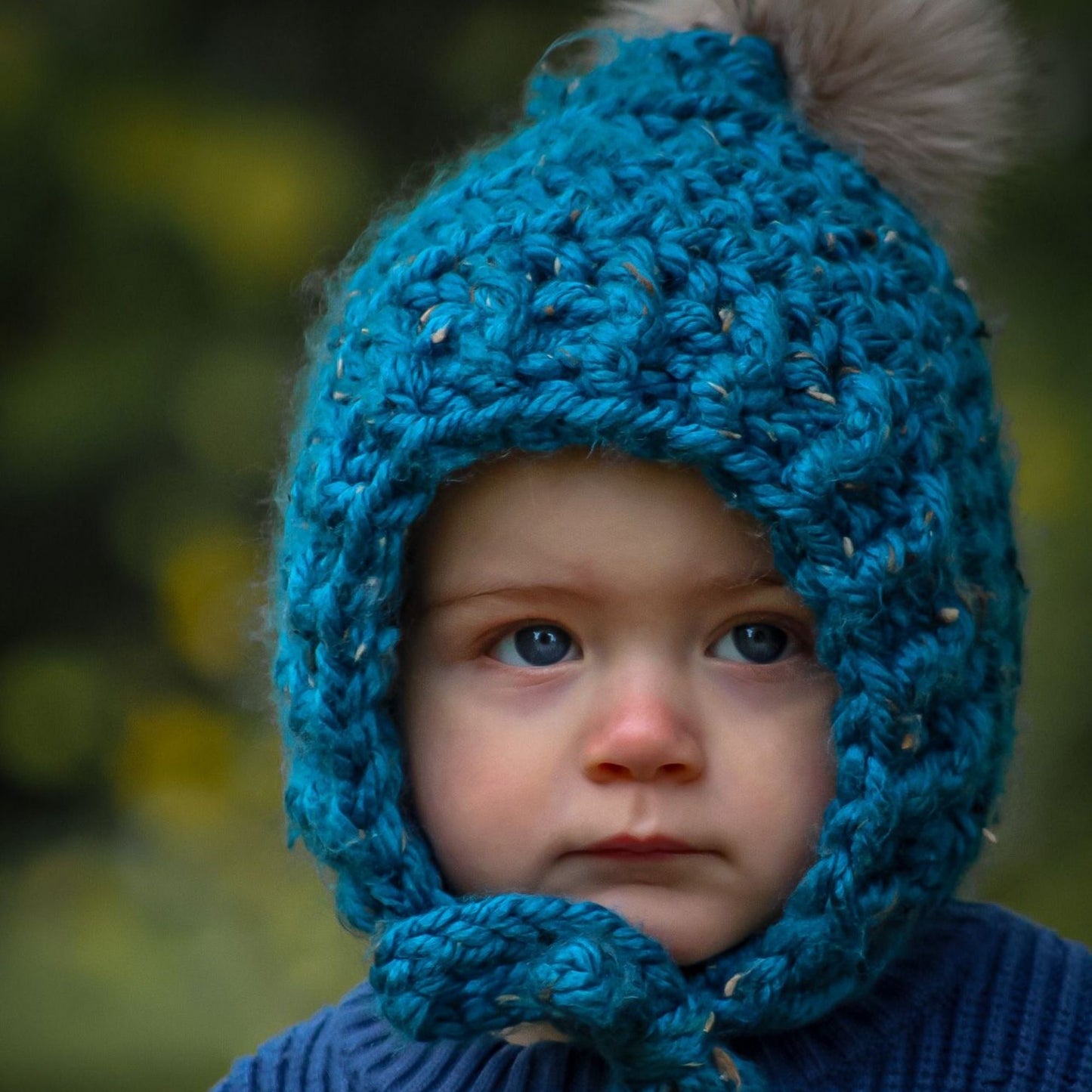 Fitted pixie bonnet with faux fur pompom