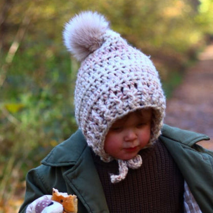 Fitted pixie bonnet with faux fur pompom