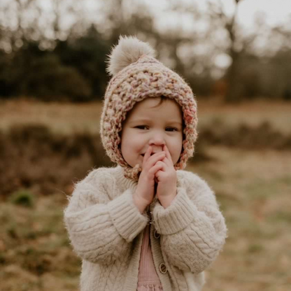 Fitted pixie bonnet with faux fur pompom